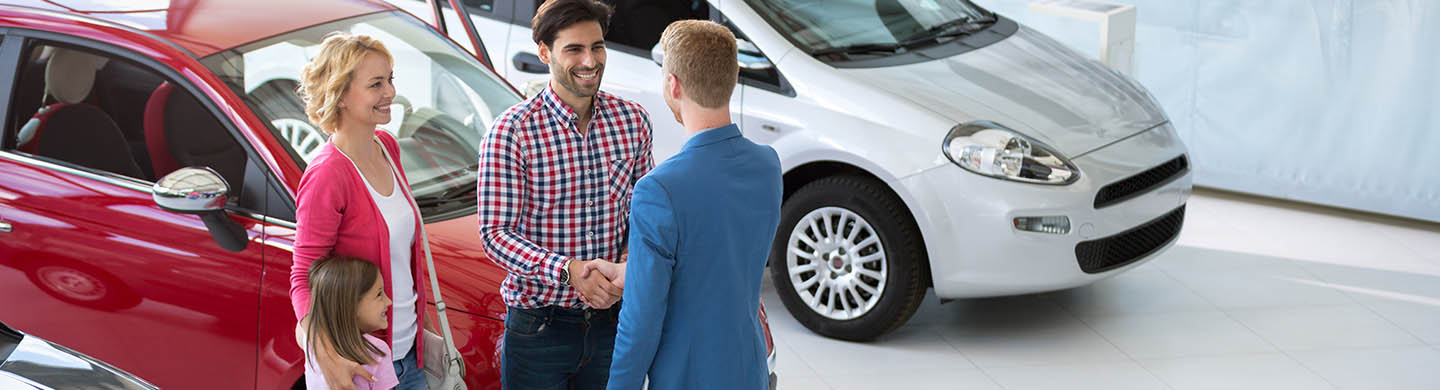 Automotive sales professional greeting customers
