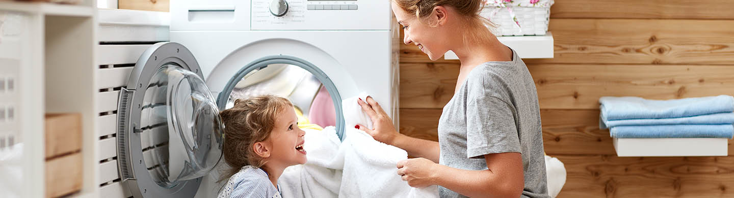 Homeowner using energy efficient laundry appliances