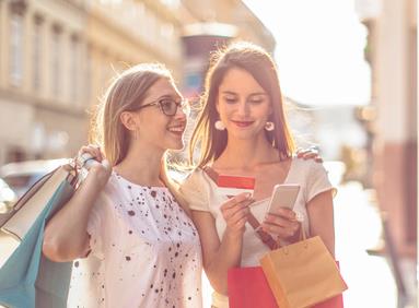 Mobile devices being used by millennial women to shop