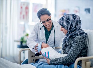 Female physician with a mother and her newborn boy