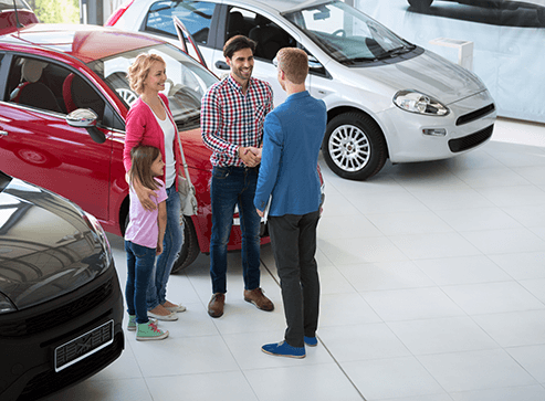 photo-of-family-in-a-car-dealership
