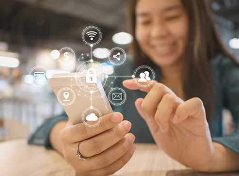 Young woman smiling and using smartphone and with icon graphic symbol