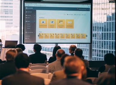 Audience watching a presentation with data screens at an Environics Analytics event