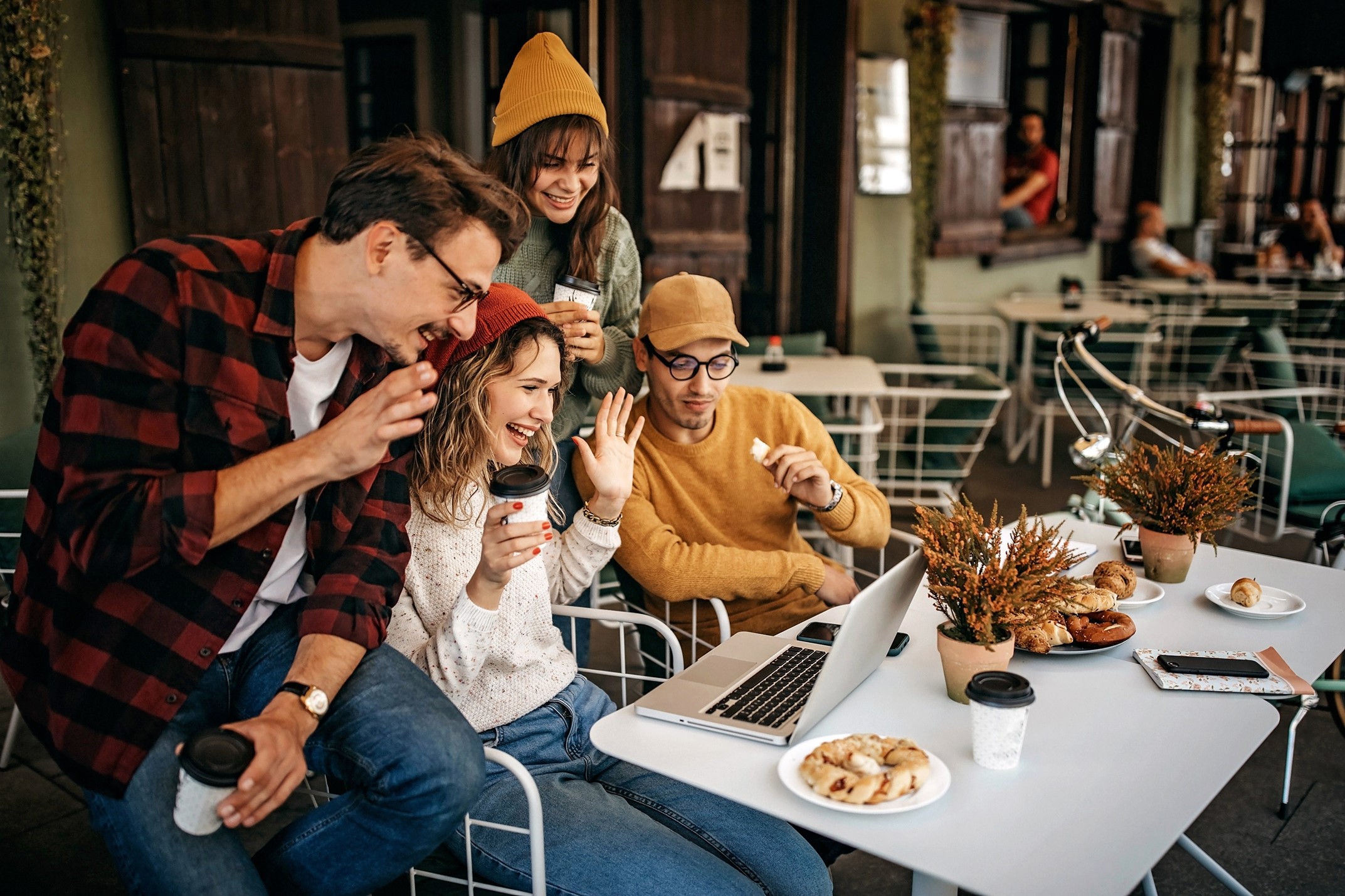 Millennials waving at a laptop screen