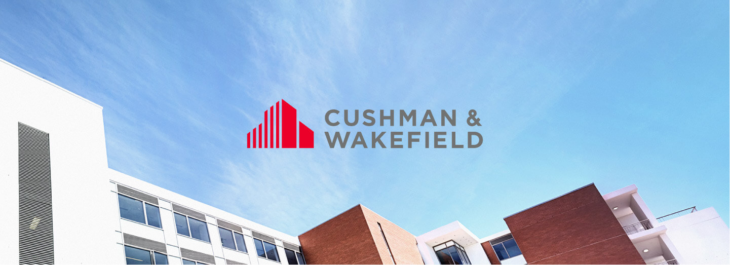 View of the top of buildings with Young girl pretending to be a superhero with Cushman and Wakefield logo in the centre of image