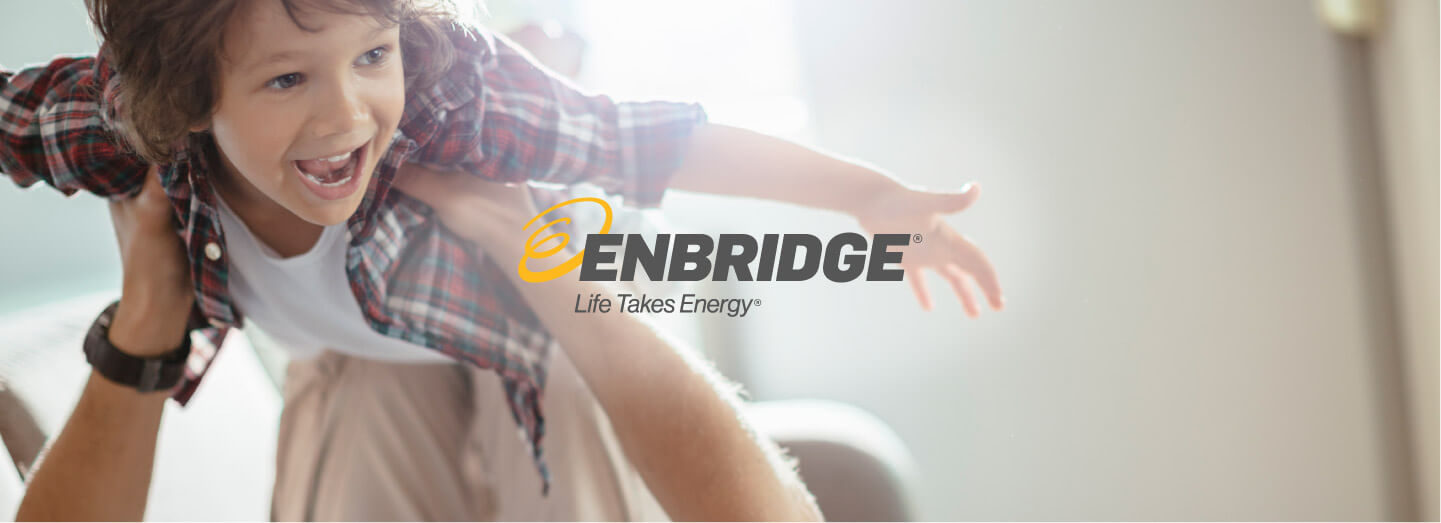 Man and son playing together with Enbridge logo in the centre of image