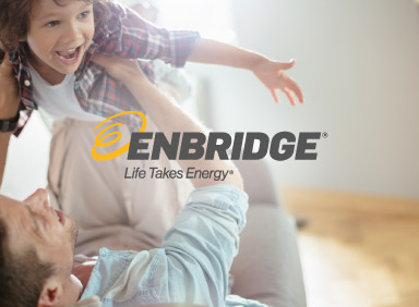 Man and son playing together with Enbridge logo in the centre of image