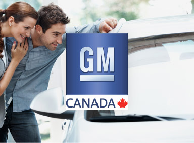 Young couple admiring new General Motors car with GM Canada logo in the centre of the image