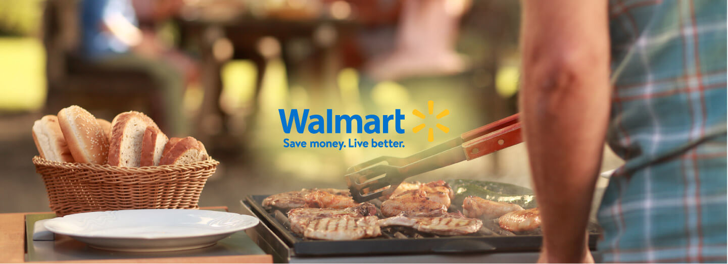 Meat sizzling on a barbecue with Walmart logo in the centre of image
