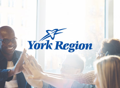 People smiling and giving high fives with York Region logo in centre of image