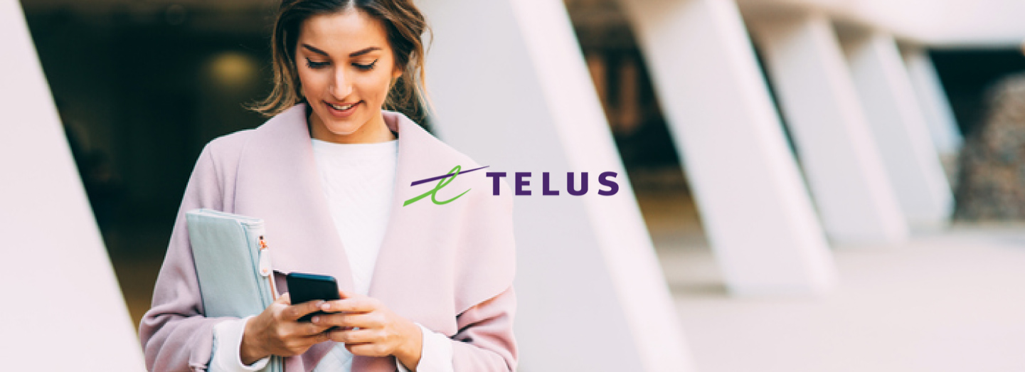 Professional woman texting on her smartphone  with Telus logo