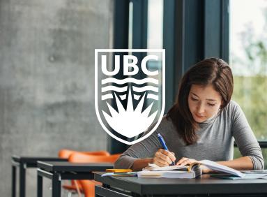 Young woman studying on a campus bench at UBC