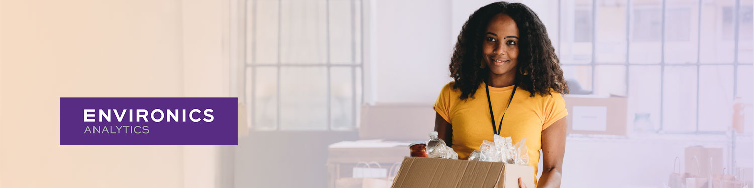 Smiling person holding a box of donations beside the Environics Analytics logo, for the giving report webinar