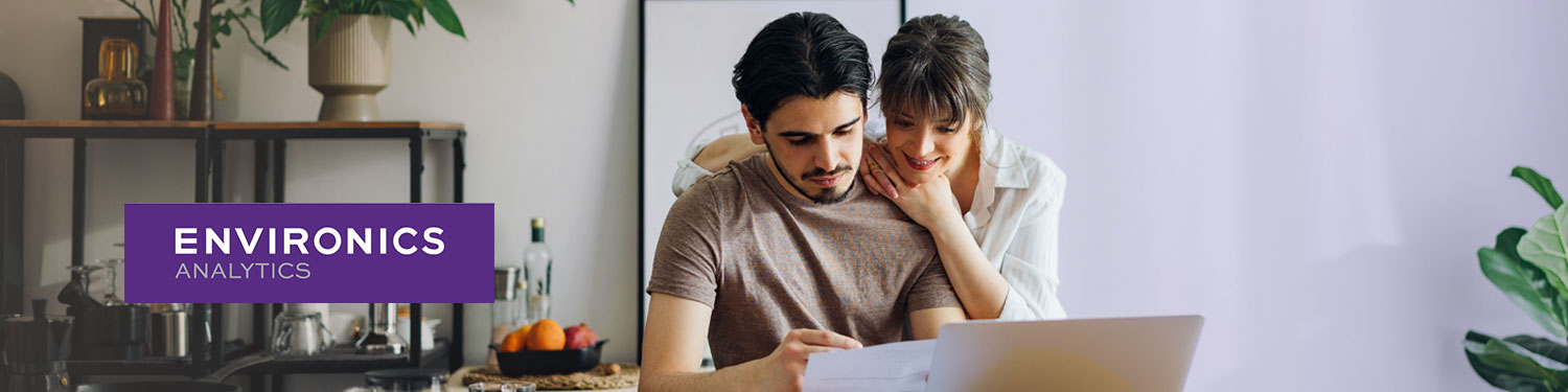 Couple looking at a laptop together on a banner for the Environics Analytics wealth webinar