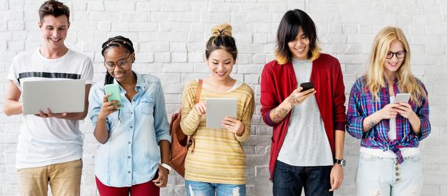 Group of young people using a laptop, tablet and smartphones, illustrating the telecommunications category