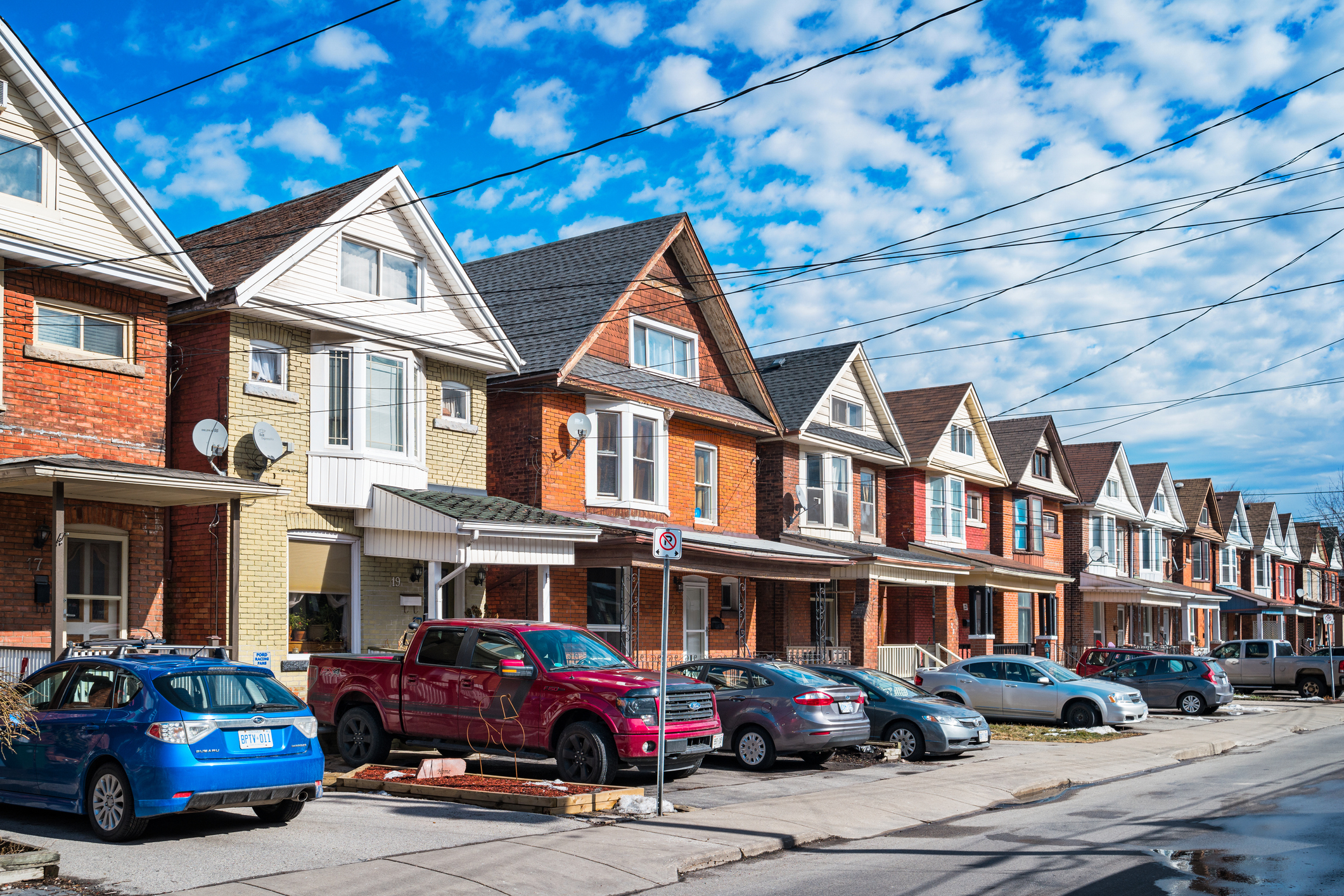 Row of houses with cars in the driveways