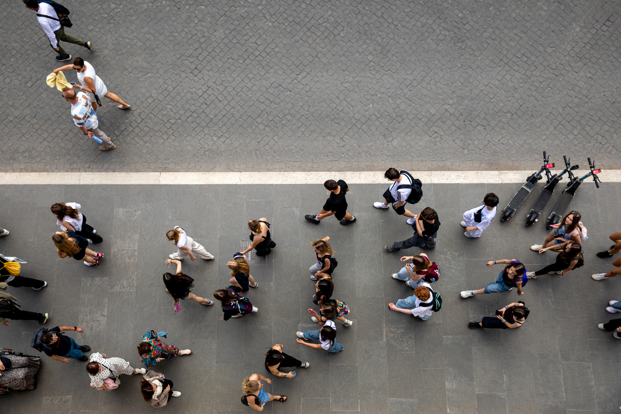 Top Down View of Pedestrians Walking Through Urban Public Space