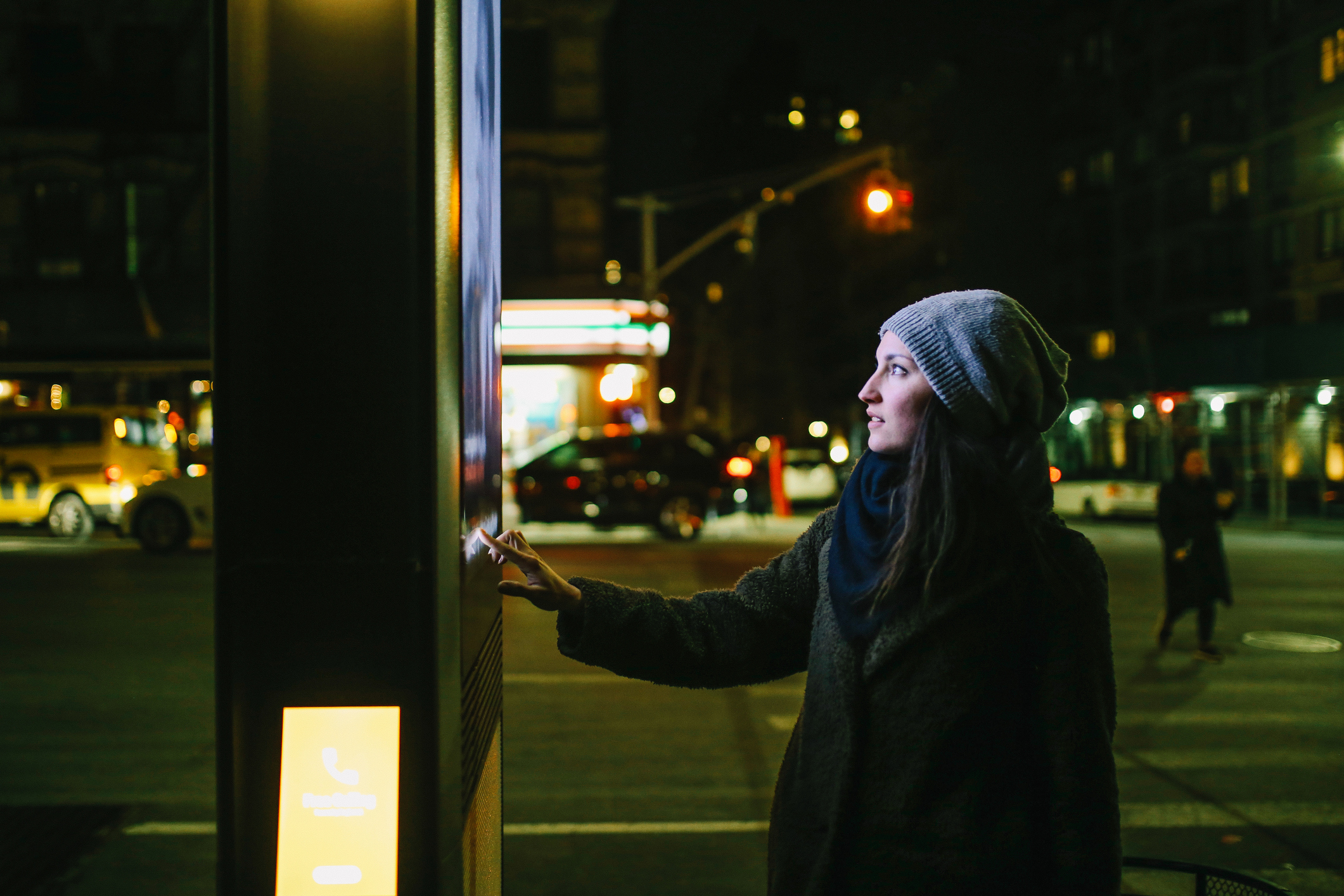 woman using touchscreen city display